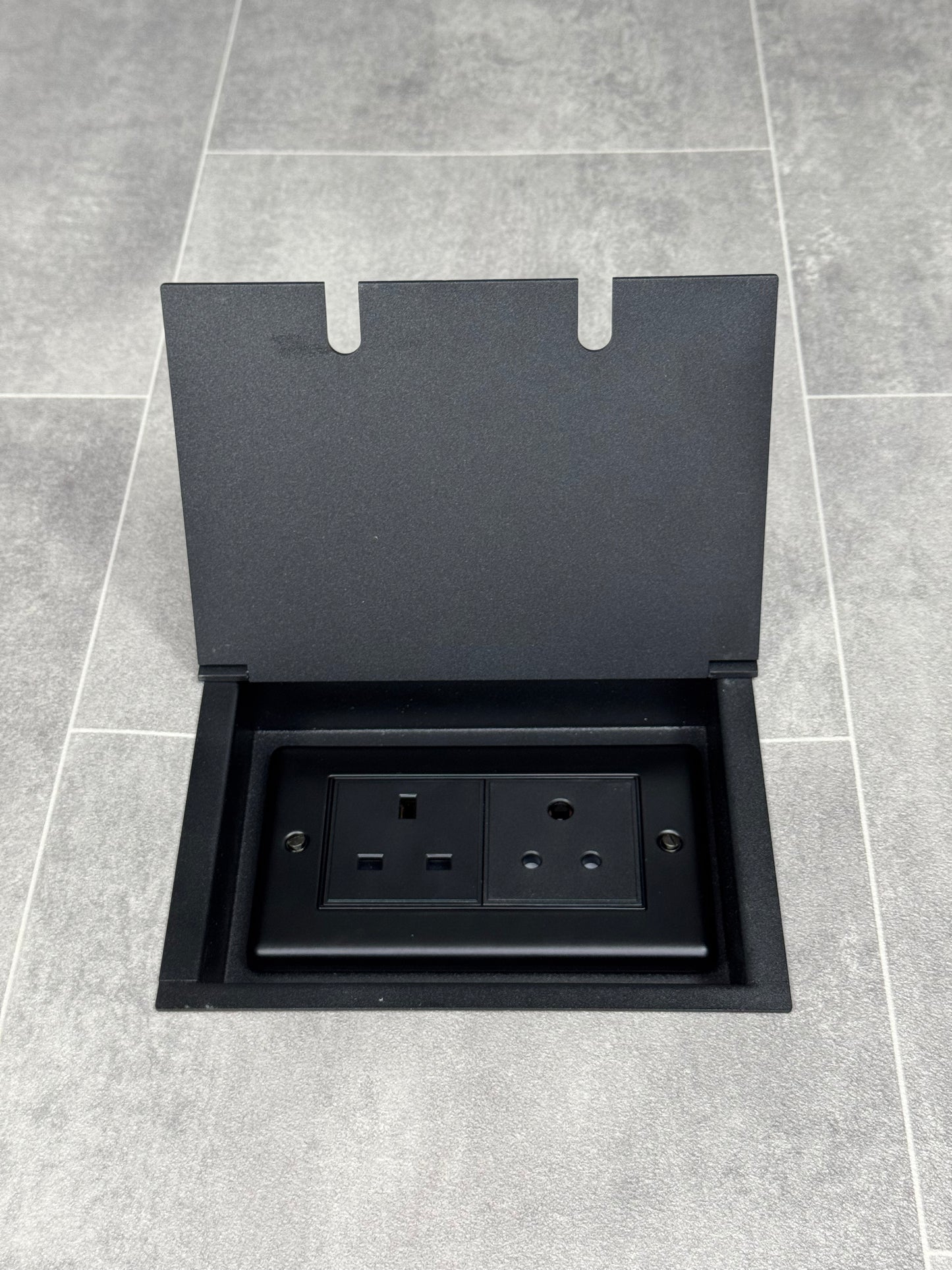 Recessed floor socket double box in matt black with one 13 amp and one 5 amp unswitched socket.