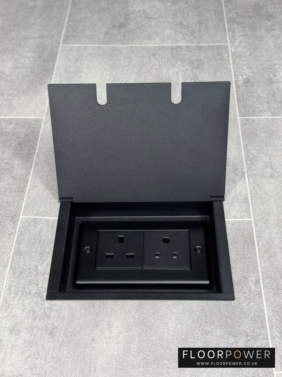 Recessed floor socket double box in matt black with one 13 amp and one 5 amp unswitched socket.