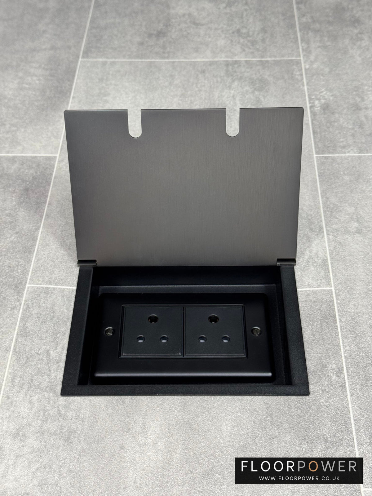 Old bronze recessed floor socket opened to show the 5amp unswitched round pin socket for lighting.