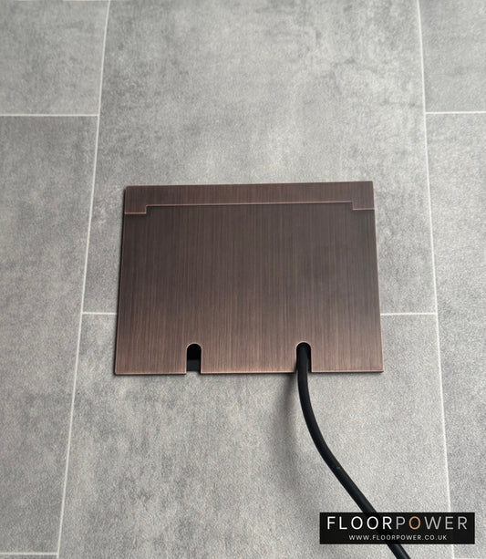 Double Antique Copper Recessed Floor Socket With Lid Closed Flat Showing Just Cable Coming Out If The Socket - Front On View