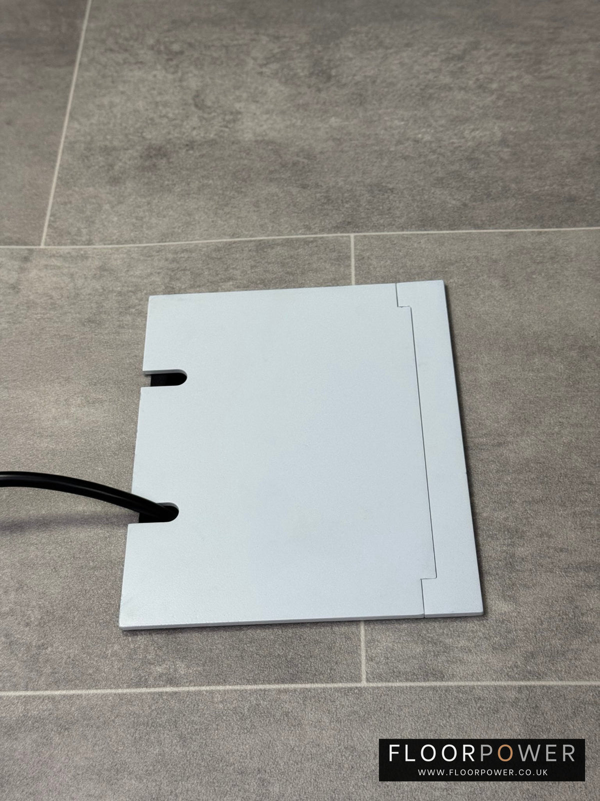 Double Matt White Recessed Floor Socket With Lid Closed Flat Showing Just Cable Coming Out If The Socket - Side On View.