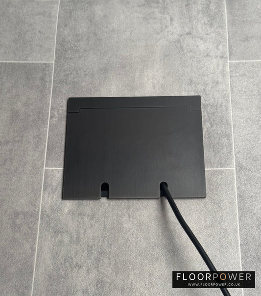 Double Old Bronzes Recessed Floor Socket With Lid Closed Flat Showing Just Cable Coming Out If The Socket - Front On View.