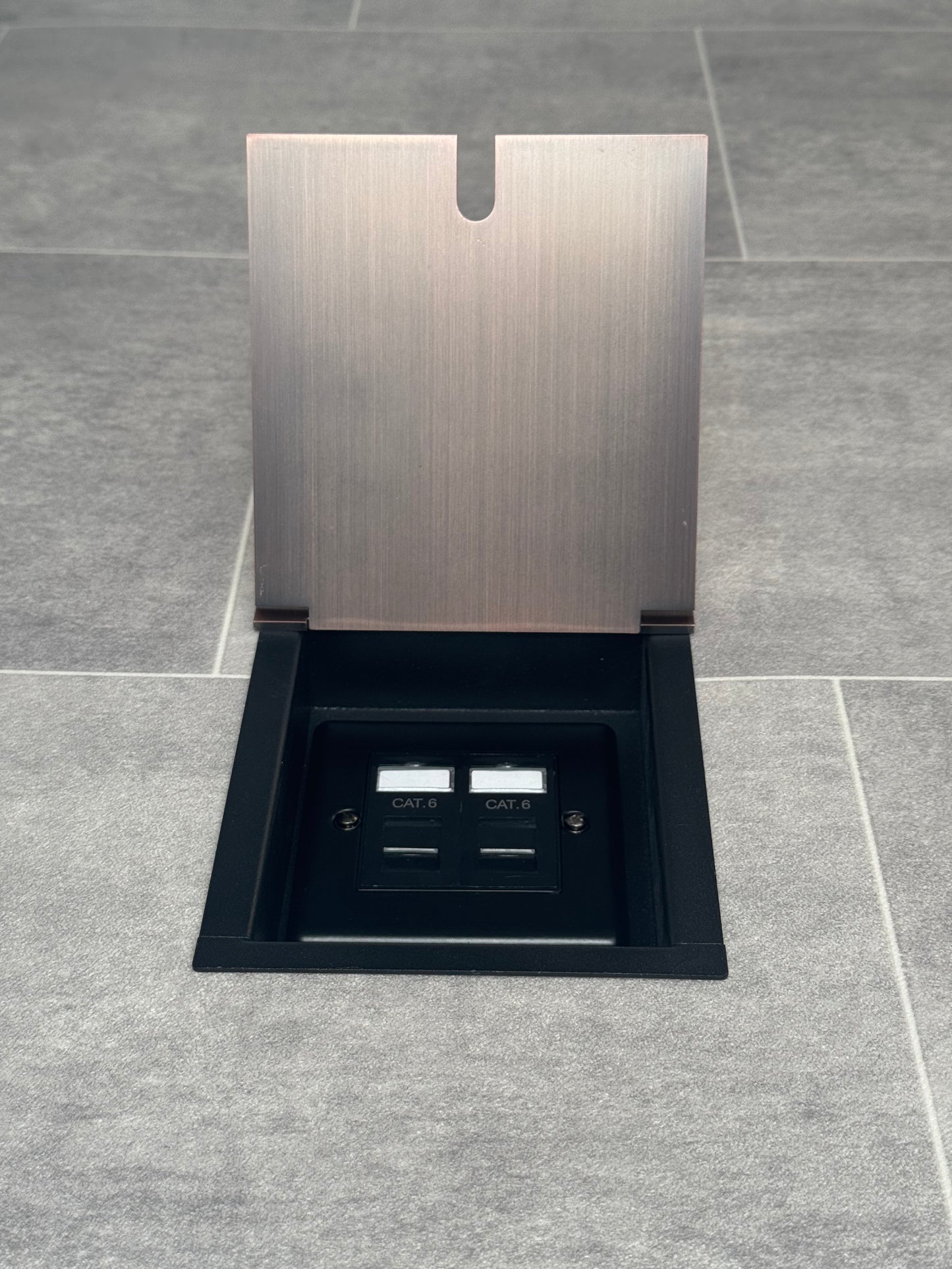 Recessed floor socket with antique copper finish and a 2 gang Cat6 RJ45 Ethernet socket.
