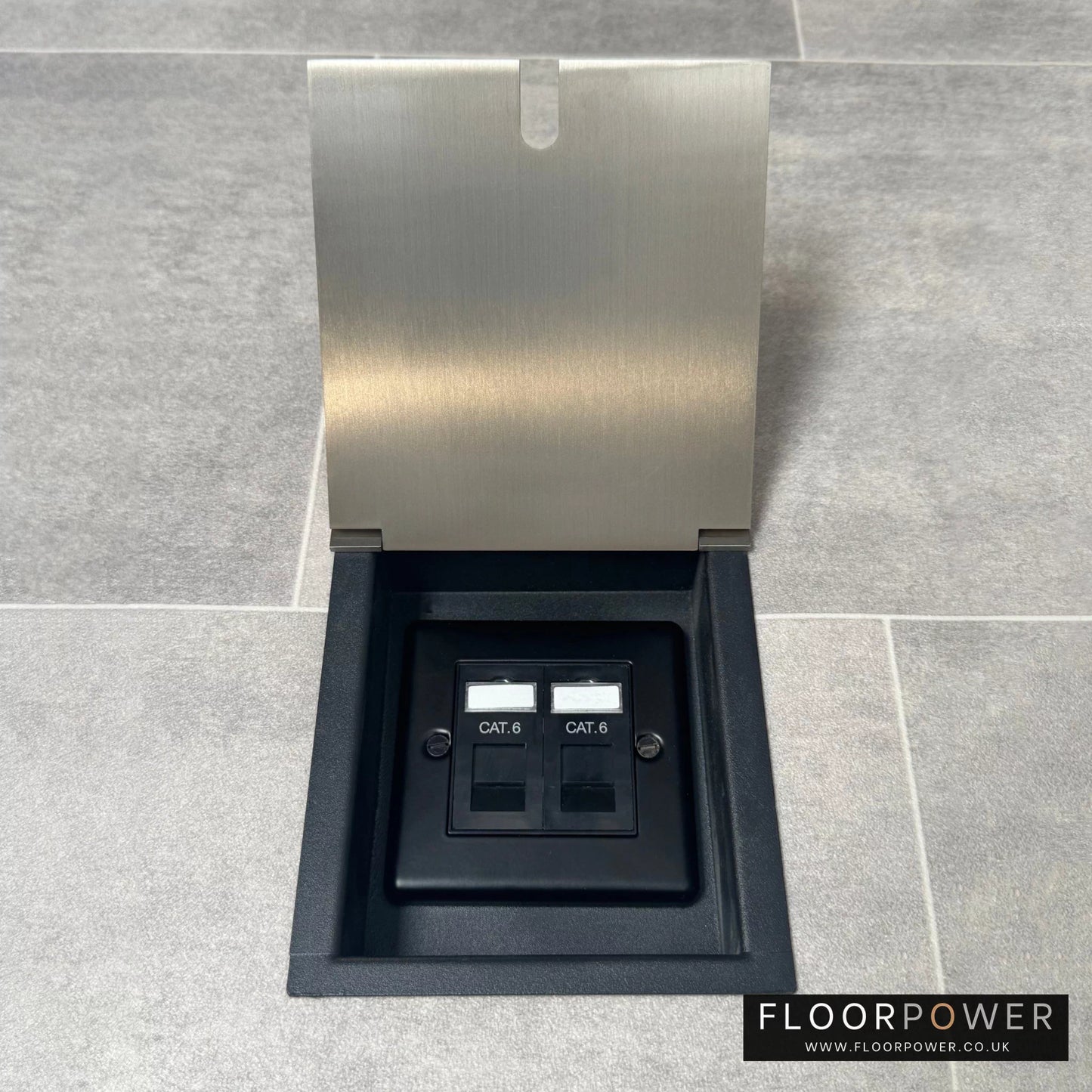 A recessed floor socket with a satin nickel cover, two RJ45 sockets, designed for network cable management.