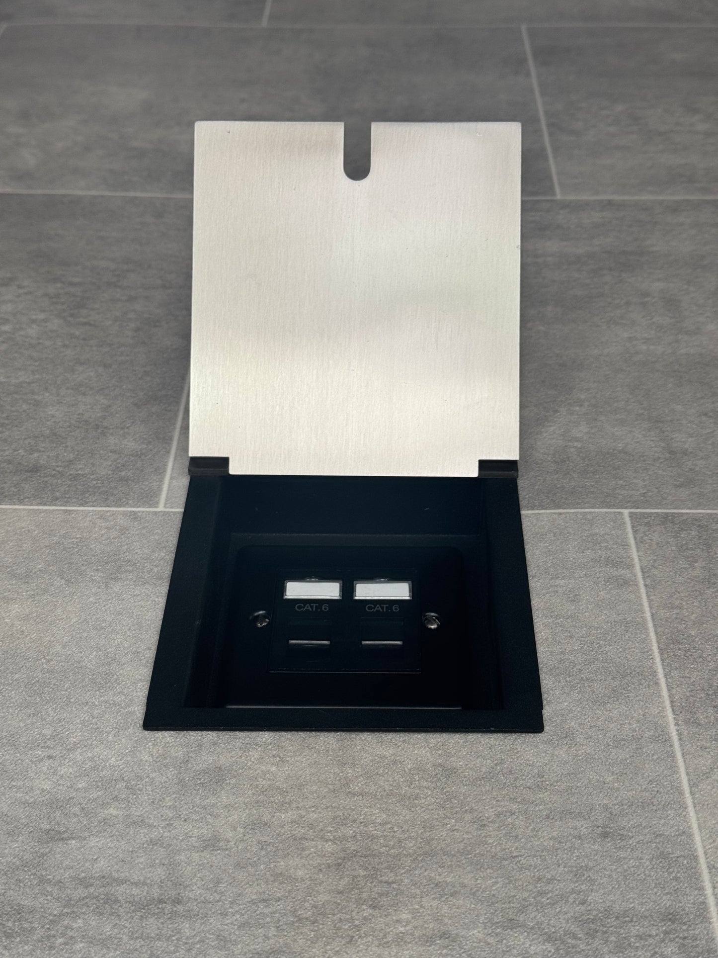 A satin stainless recessed floor socket with a 2 gang Cat6 RJ45 Ethernet socket.