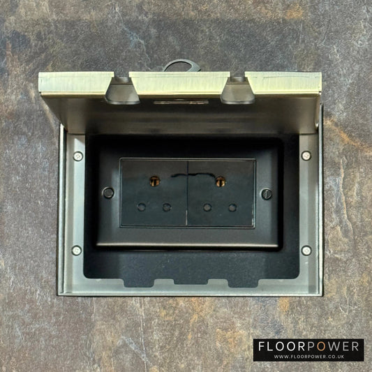 Antique Brass Double Recessed Flush Floor Socket with 5A Round Pin Sockets for Lighting in a stone floor.