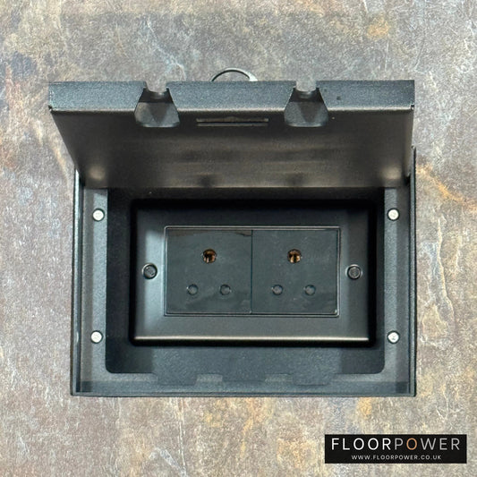 Matt Black Double Recessed Flush Floor Socket with 5A Round Pin Sockets for Lighting in a stone floor.
