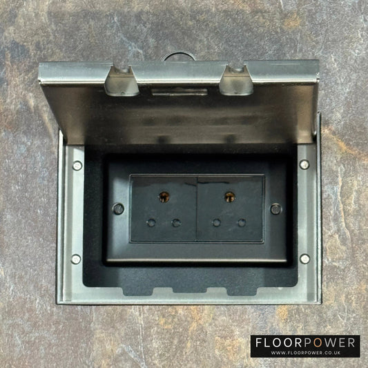 Old Bronze Double Recessed Flush Floor Socket with 5A Round Pin Sockets for Lighting in a stone floor.