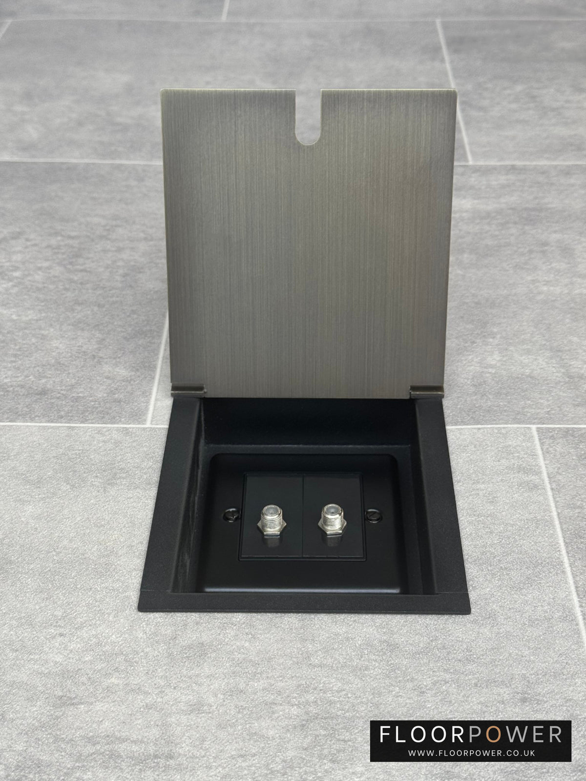 An antique brass recessed floor socket with two satellite F connectors for dual satellite feed.