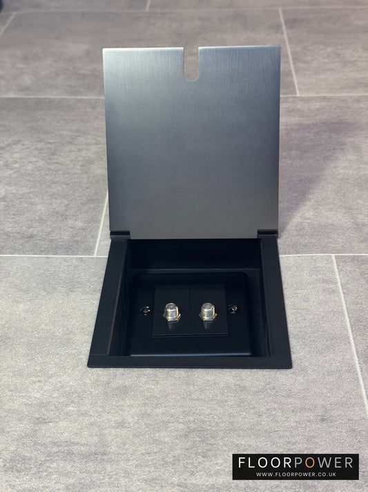 A single old bronze recessed floor socket with a 2 gang satellite socket.