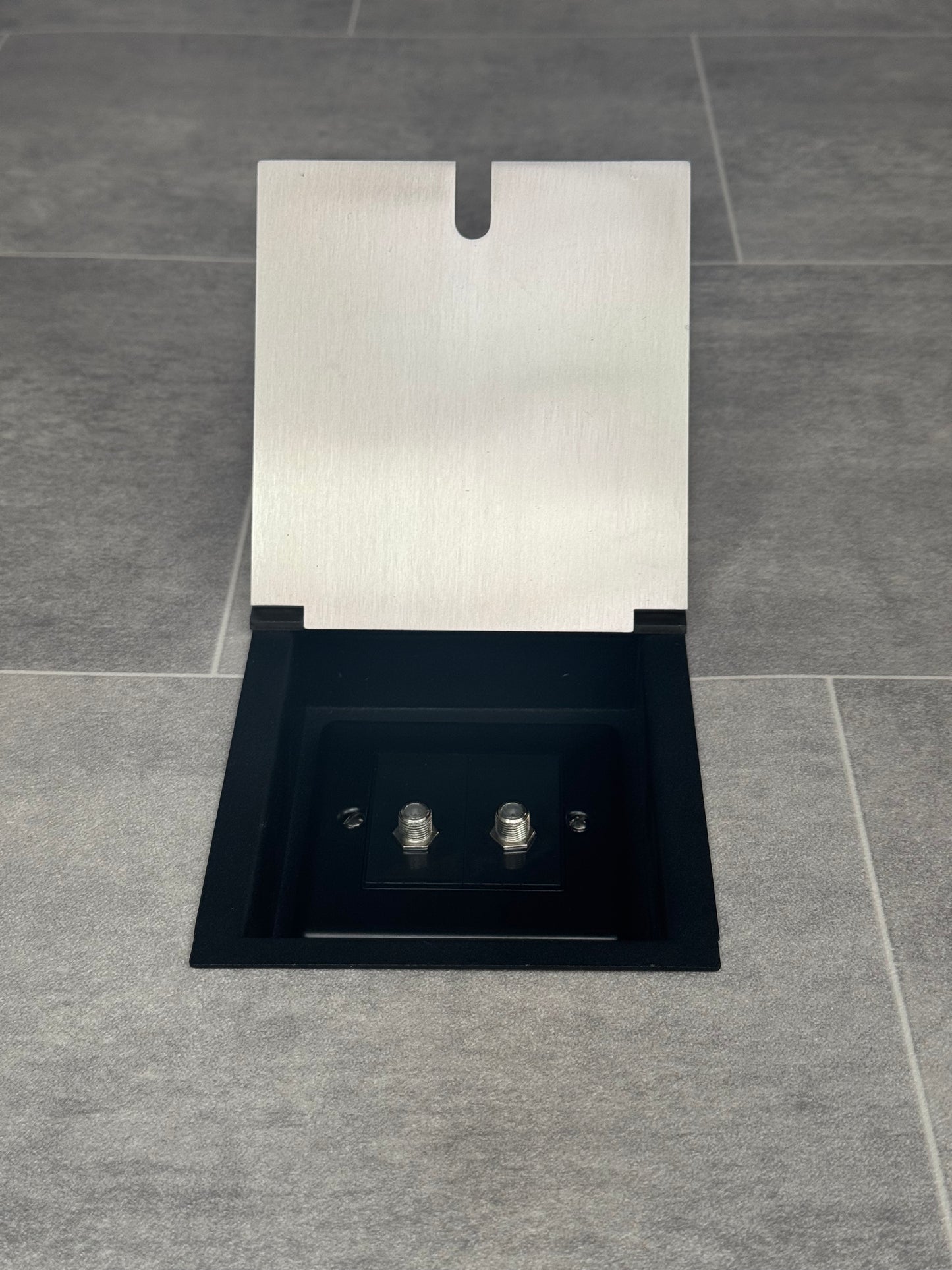 A satin stainless recessed floor socket with 2 satellite connectors.