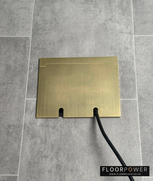 Double Satin Brass Recessed Floor Socket With Lid Closed Flat Showing Just Cable Coming Out If The Socket - Front On View.