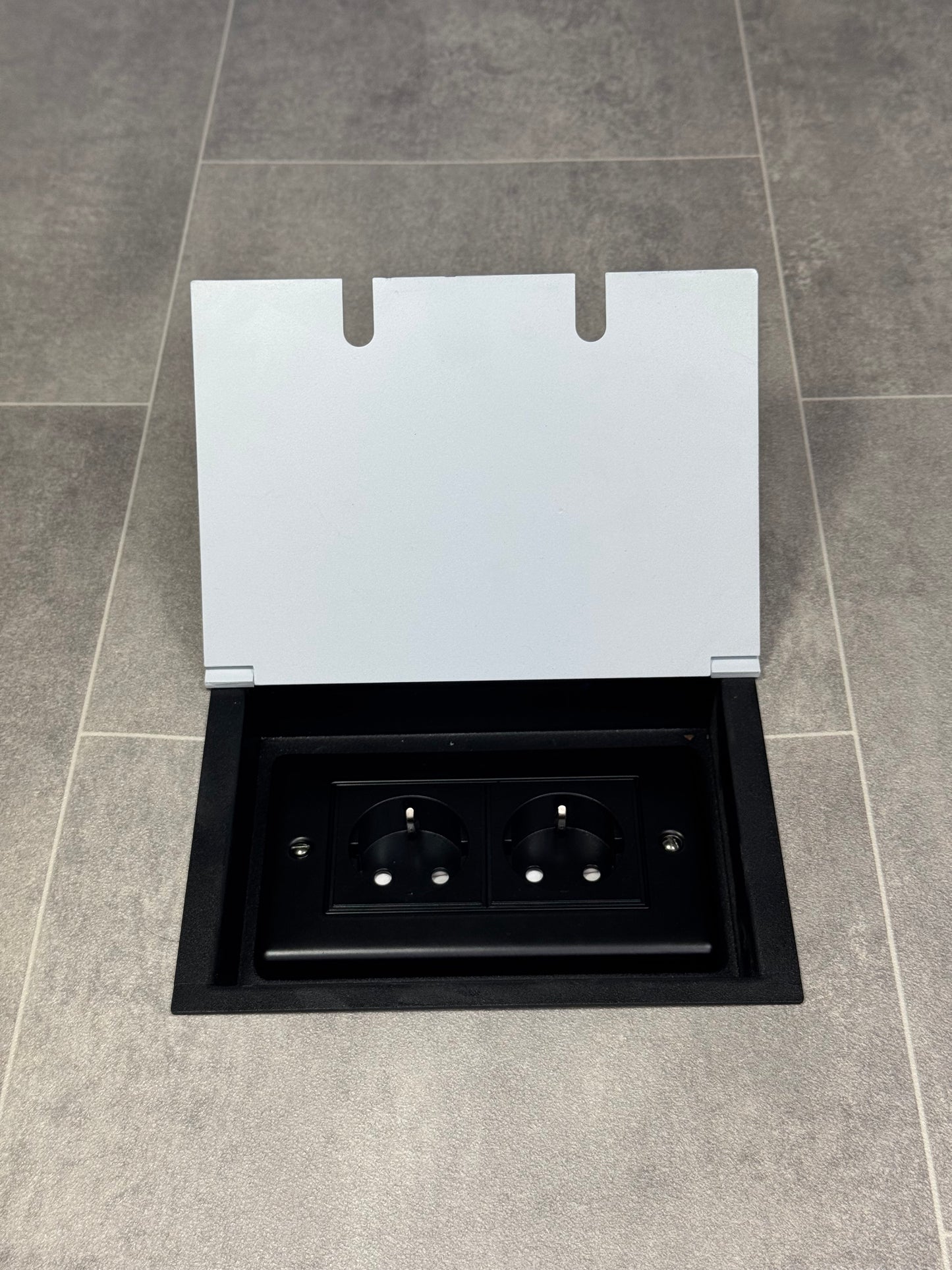 White recessed floor socket with a double (2 Gang) Schuko (European) plug socket.