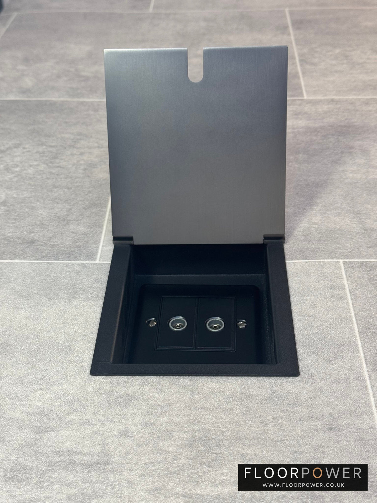Old bronze recessed floor socket with a 2 gang TV socket, shown in an open position with the surrounding floor visible.