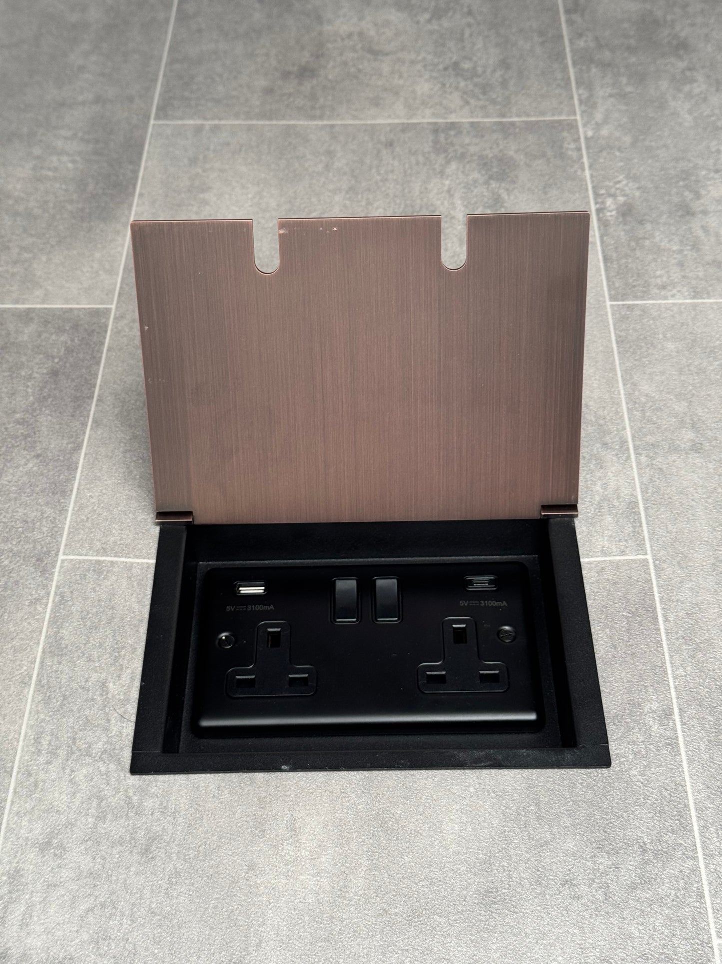 Antique copper recessed floor socket with a double USB A + C plug socket.