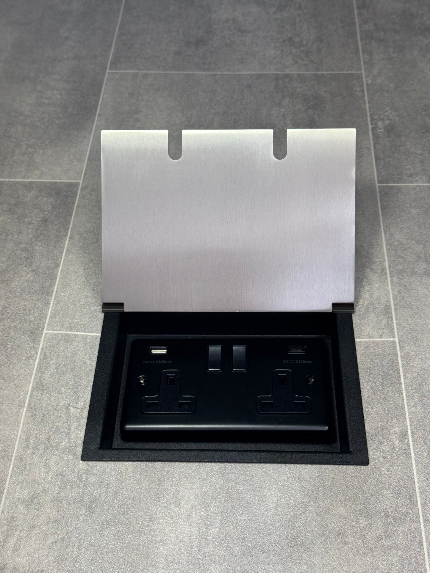 A satin stainless steel double recessed floor socket with a 13 amp switched socket and USB A+C ports.