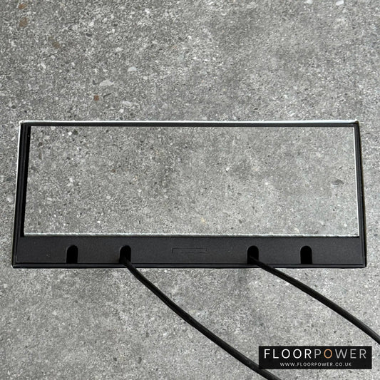 Flush Recessed Floor Socket with Black Surround in grey stone floor showing closed lid and 2 wires coming out