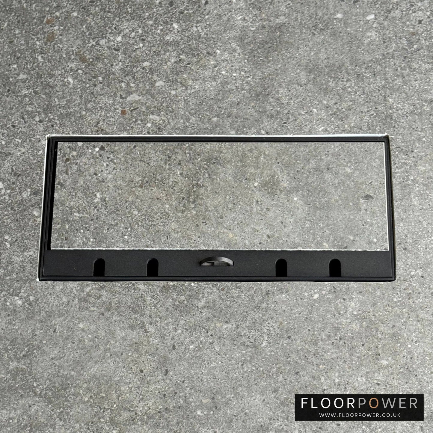 Flush Recessed Floor Socket with Black Surround in grey stone floor showing the lid handle in the up position