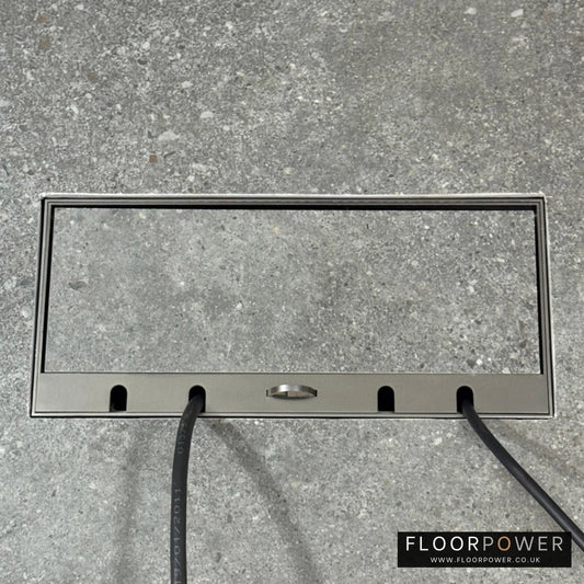 Flush Recessed Floor Socket with Old Bronze Surround in grey stone floor showing closed lid and 2 wires coming out