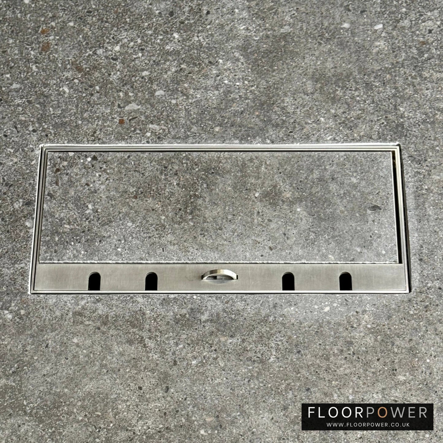 Flush Recessed Floor Socket with Satin Stainless Surround in grey stone floor showing the lid handle in the up position