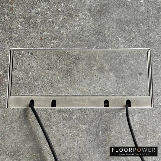 Flush Recessed Floor Socket with Satin Stainless Surround in grey stone floor showing closed lid and 2 wires coming out