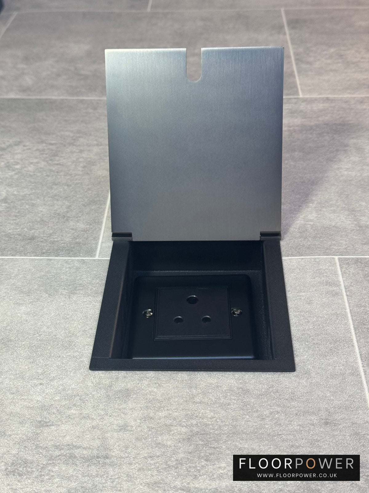 Recessed floor socket in old bronze with the cover open showing the single 5 Amp round pin socket for lighting.