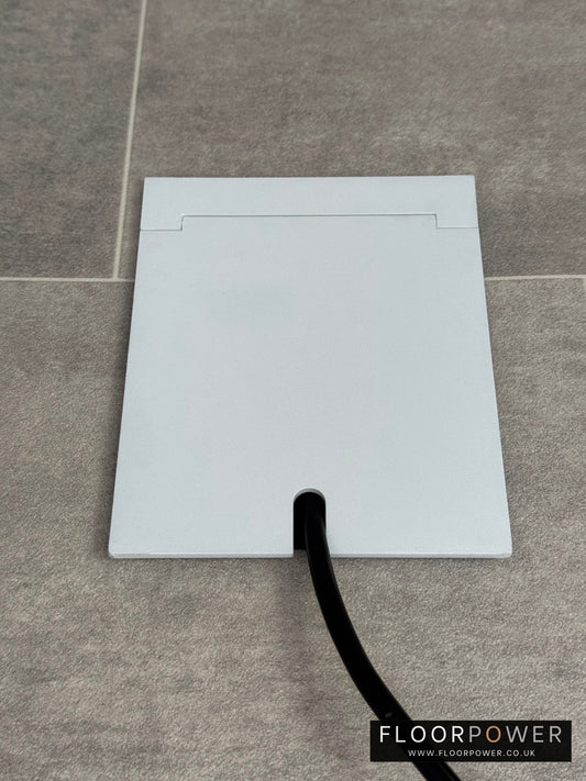 Single Matt White Recessed Floor Socket With Lid Closed Flat Showing Just Cable Coming Out If The Socket - Front On View.