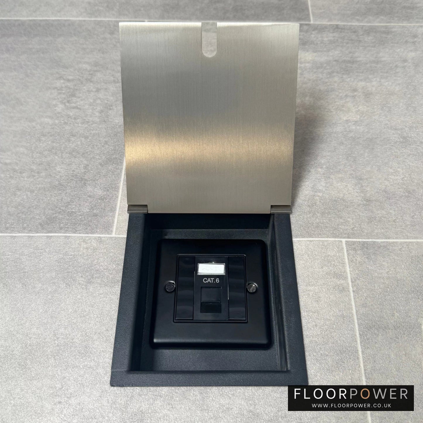 A satin nickel finish recessed floor socket with a black base, opened to reveal the internal Cat6 RJ45 socket.