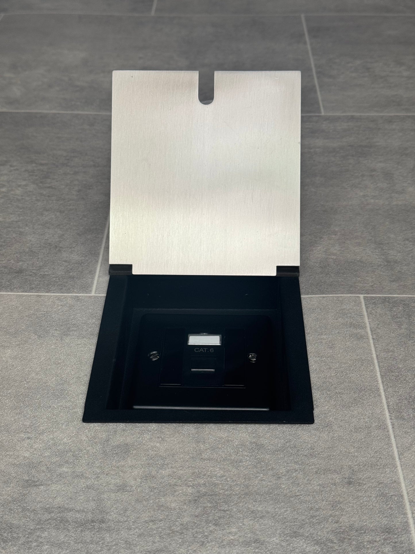 A satin stainless recessed floor socket with a black base, opened to reveal the internal Cat6 RJ45 socket.