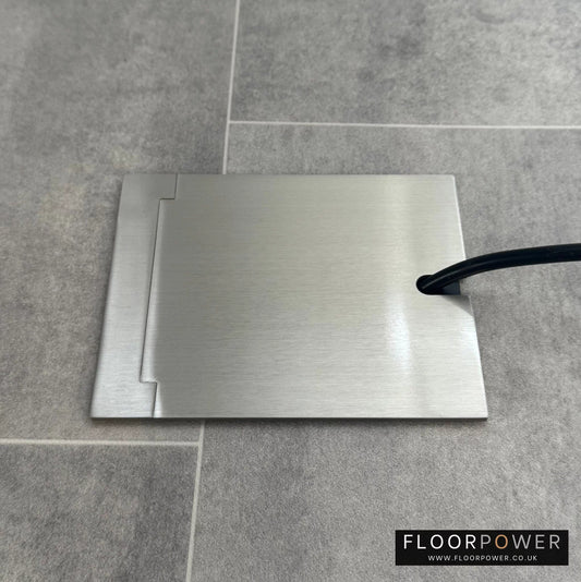 Single Satin Nickel Recessed Floor Socket With Lid Closed Flat Showing Just Cable Coming Out If The Socket - Side On View.