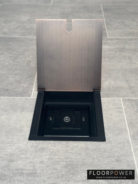 Antique copper recessed floor socket with a single gang TV socket, opened to show the socket.