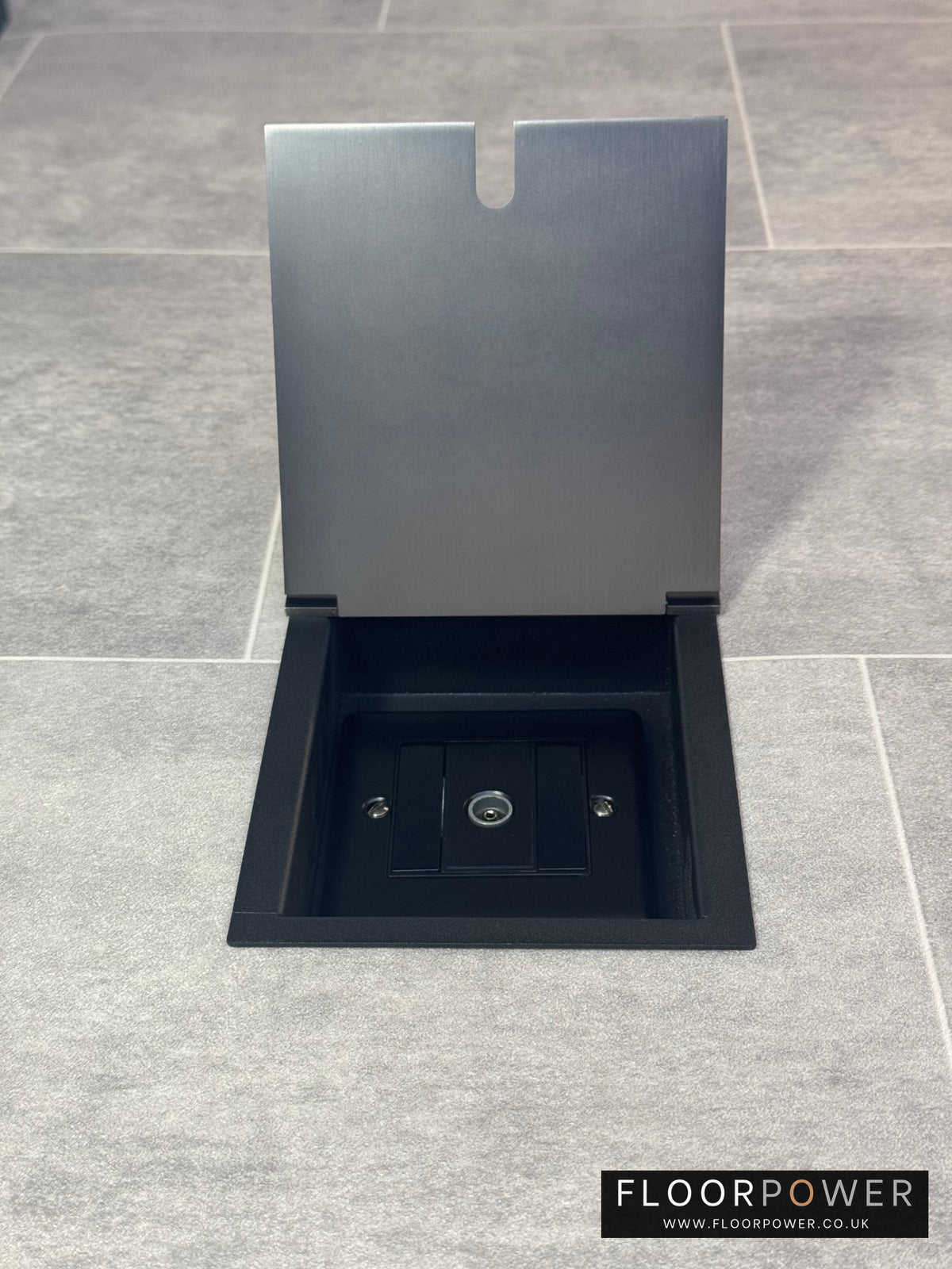 Recessed floor socket in old bronze installed on a tiled floor, featuring a 1 gang TV socket.
