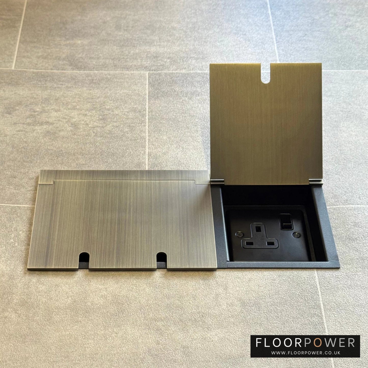 Triple plug floor socket in Antique Brass with single 13A switched plug socket lid open.