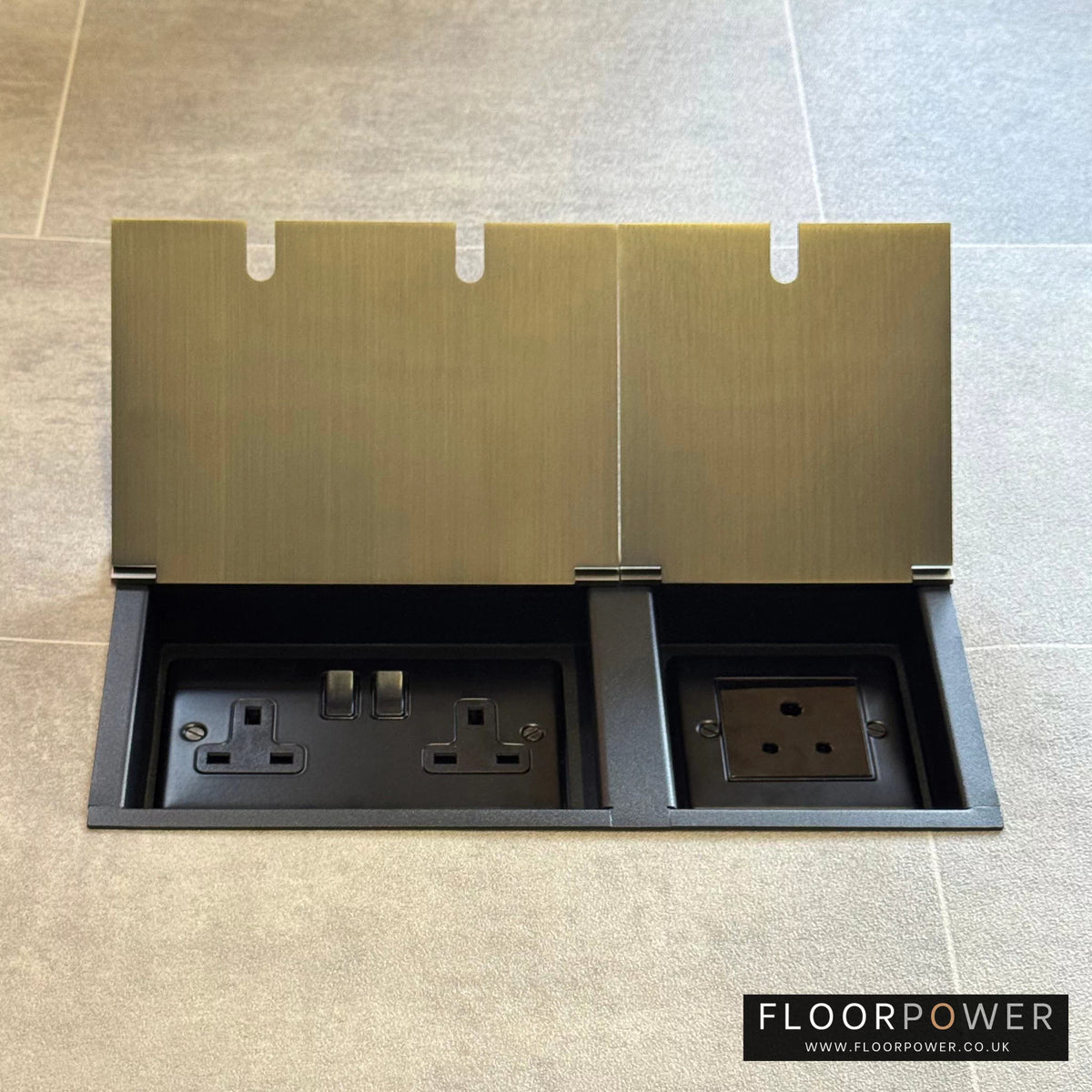 Antique Brass lighting combination triple floor socket with double 13A switched plug socket and a 5A round pin socket, both lids open.