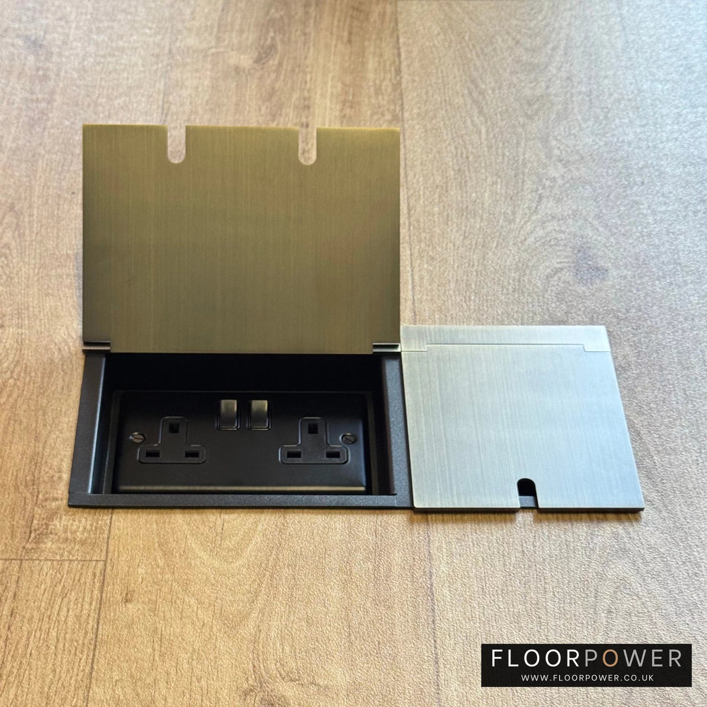 Triple Recessed Floor Socket in Antique Brass on a wood floor, with double side lid open showing plug socket.