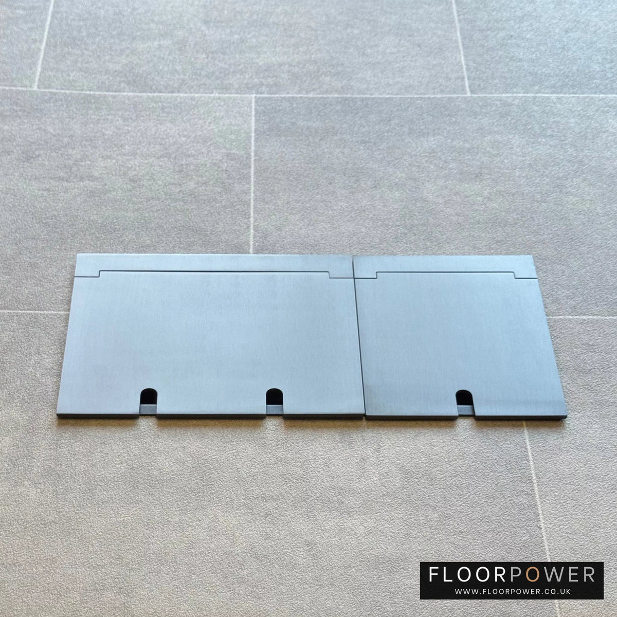 Closed Triple Recessed Floor Socket in Old Bronze on tiled floor.