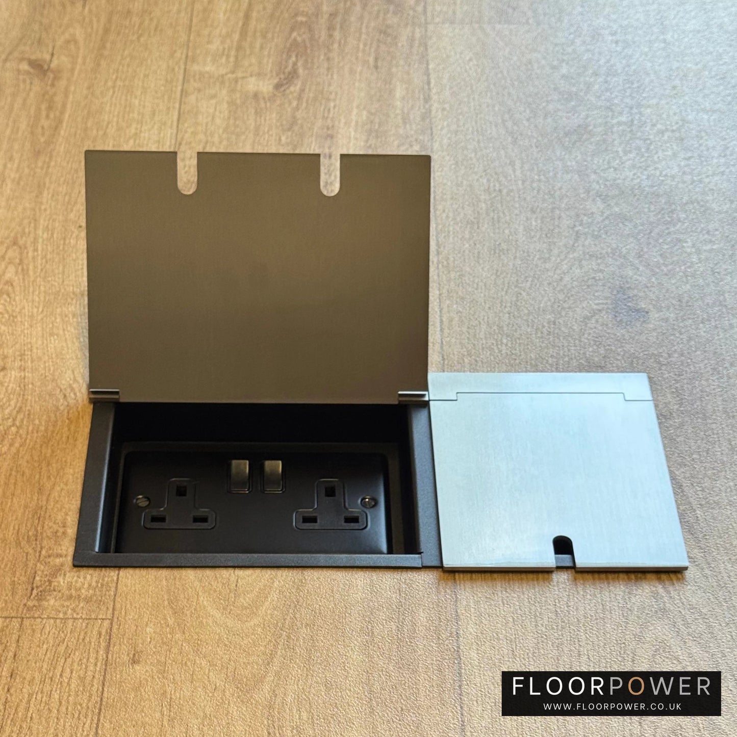 Triple Recessed Floor Socket in Satin Nickel on a wood floor, with the double side lid open showing plug socket.