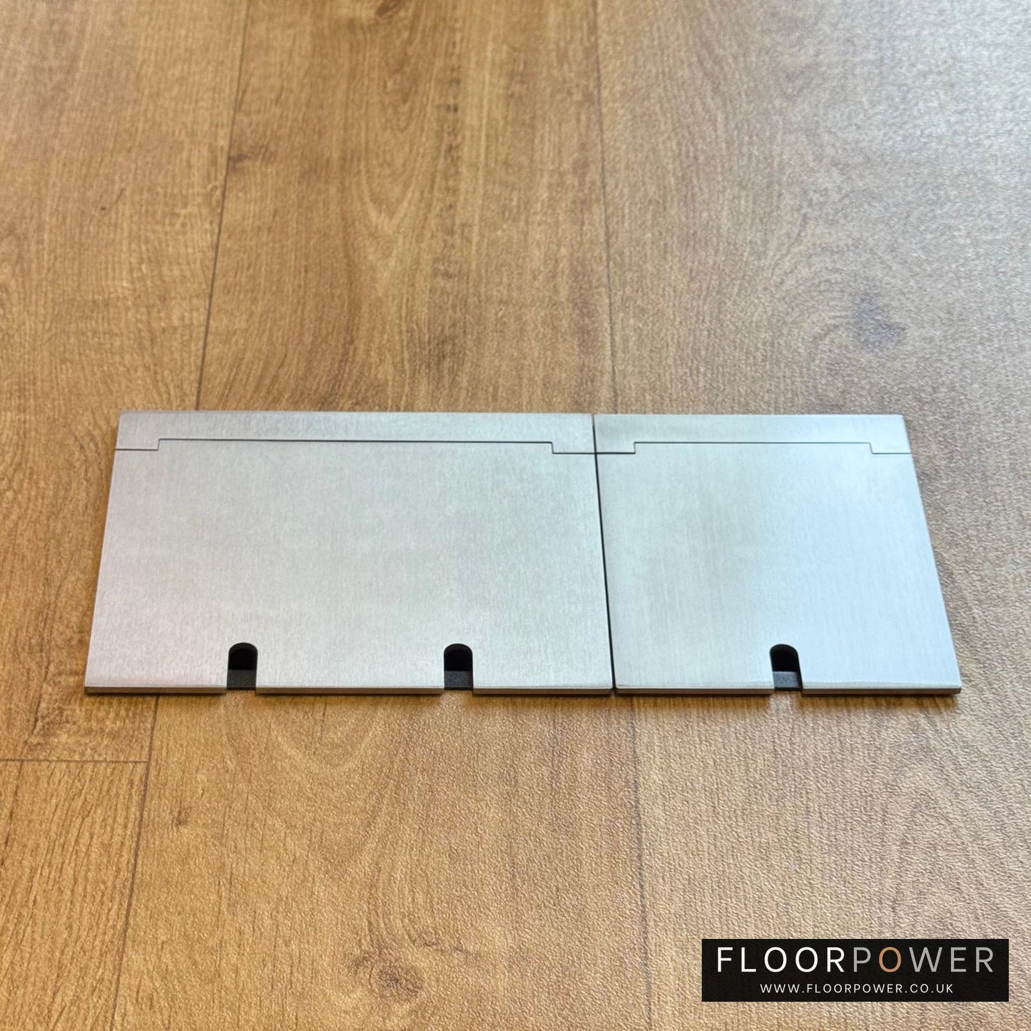 Closed Triple Recessed Floor Socket in Satin Nickel on wood floor.