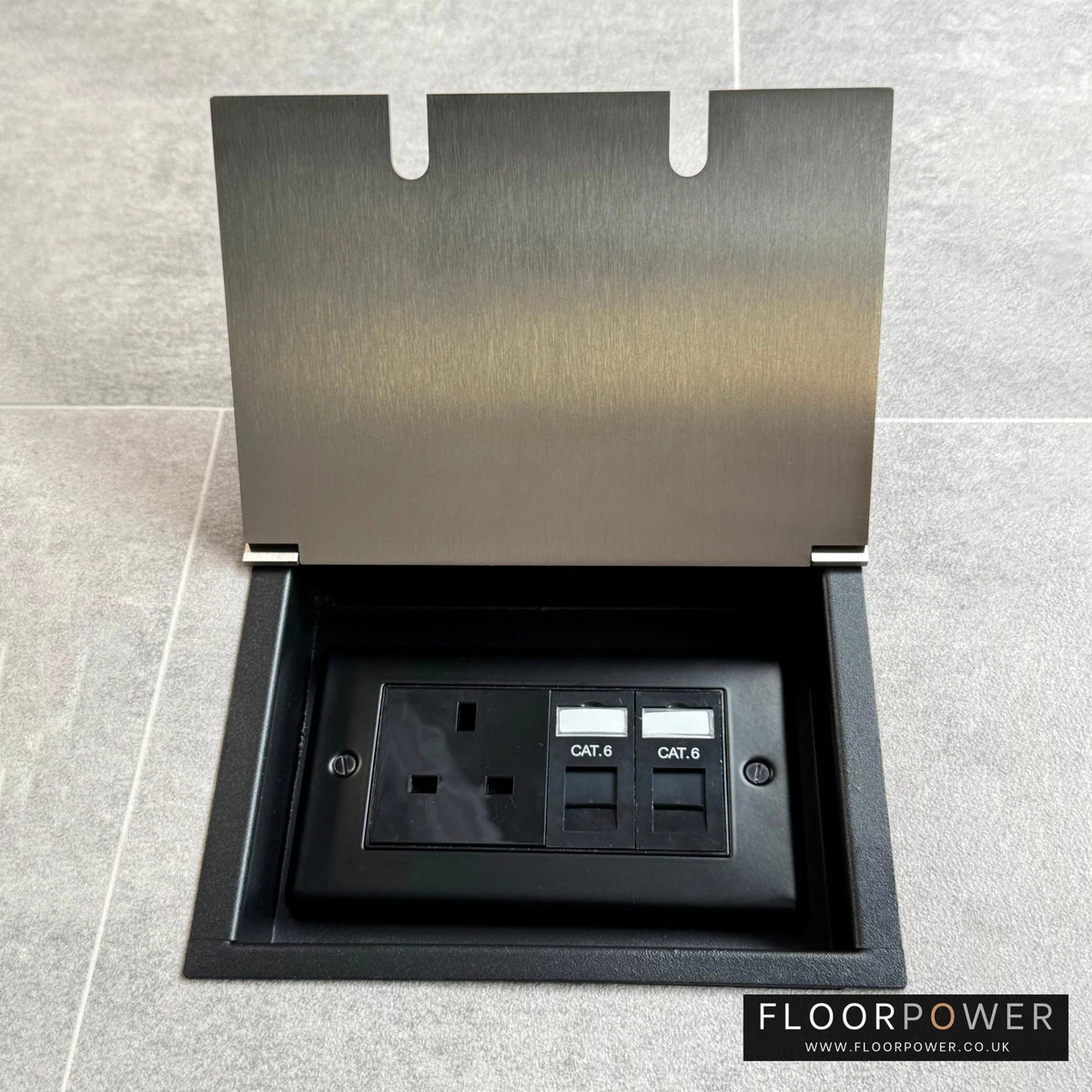 Recessed floor socket in satin nickel with a double box containing one 13amp unswitched socket and two RJ45 sockets, set in a tiled floor setting.