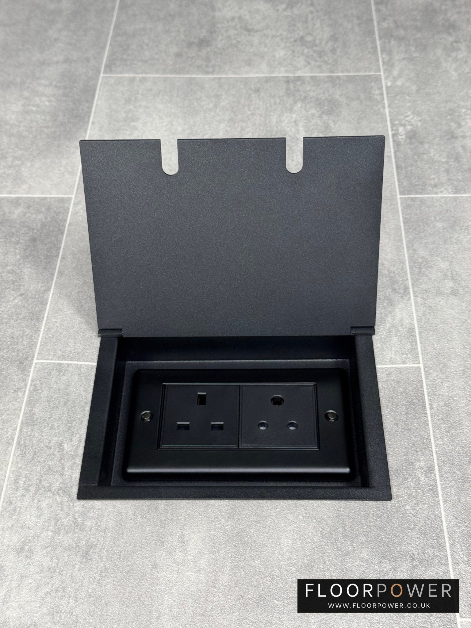 Recessed floor socket double box in matt black with one 13 amp and one 5 amp unswitched socket.