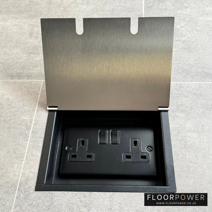 Satin nickel recessed floor socket with a double 13amp switched plug socket, in a tiled floor.