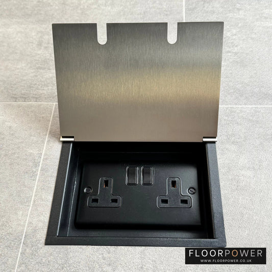 Satin nickel recessed floor socket with a double 13amp switched plug socket, in a tiled floor.