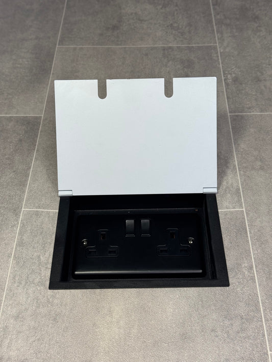 A white double recessed floor socket with a 13 amp switched plug socket installed in a floor.
