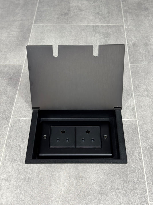 Old bronze recessed floor socket opened to show the 5amp unswitched round pin socket for lighting.