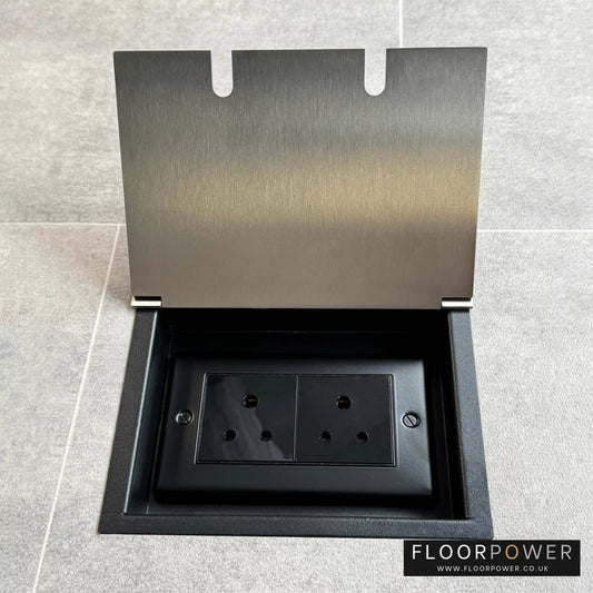 Double 5 amp recessed floor socket for lighting with satin nickel lid set into the floor.