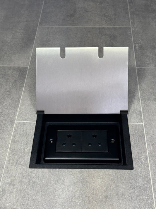 A satin stainless double recessed floor socket with two 5 amp round pin sockets used for lighting.
