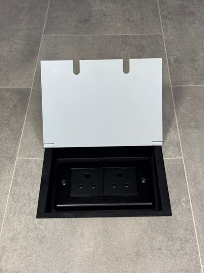 Double 5 amp recessed floor socket for lighting with white lid set into the floor.