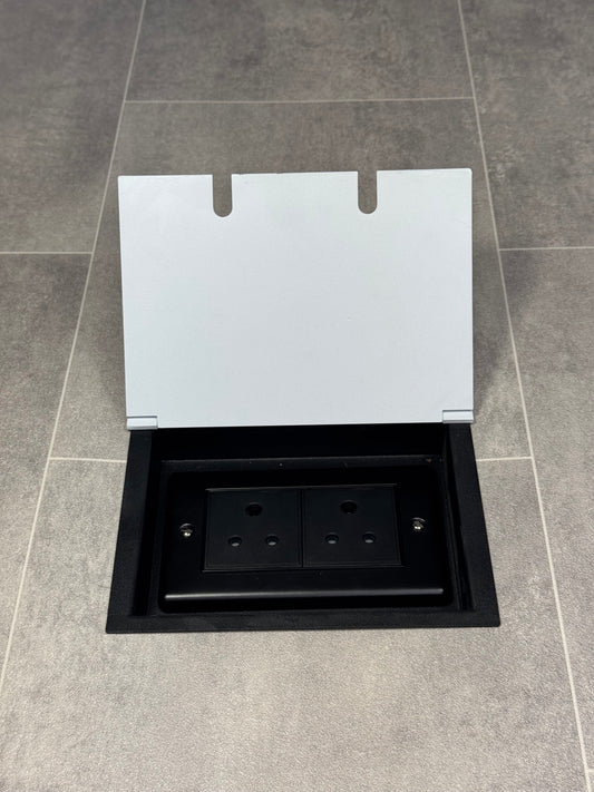 Double 5 amp recessed floor socket for lighting with white lid set into the floor.