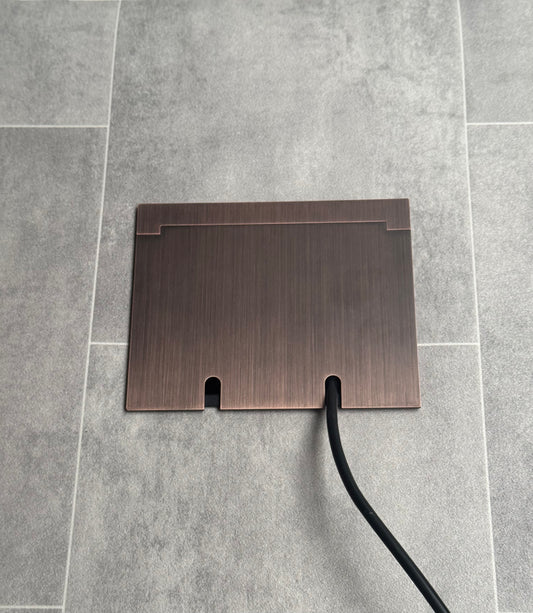 Double Antique Copper Recessed Floor Socket With Lid Closed Flat Showing Just Cable Coming Out If The Socket - Front On View