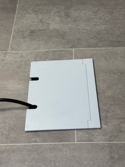 Double Matt White Recessed Floor Socket With Lid Closed Flat Showing Just Cable Coming Out If The Socket - Side On View.